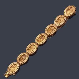 Lote 2155: Pulsera con siete eslabones ovalados con escenas con motivos mayas realizado en oro amarillo de 18K.