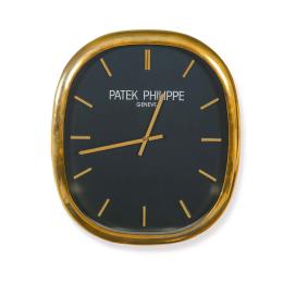 Lote 2569: Reloj de pared PATEK PHILIPPE modelo Elipse en latón dorado.