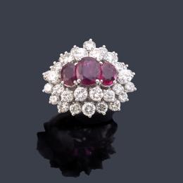 Lote 2282: Anillo con tres rubíes talla oval de aprox. 2,70 ct con doble orla de brillantes de aprox. 3,88 ct en total.