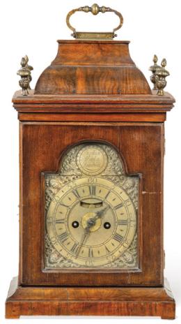 Lote 93: Reloj bracket de principios del georgiano con caja de madera de caoba con pináculos y asas en latón. Maquinaria de medio punto de latón firmada por Stephen Asselin London. Principios del siglo XVIII.