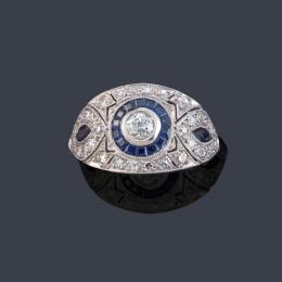 Lote 2076<br>Anillo bombé con motivo de 'ojo de perdiz' con diamante talla antigua y diamantes talla 8/8 de aprox. 1,20 ct en total y orla de zafiros calibrados.